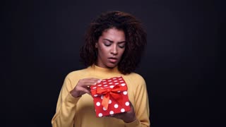 videoblocks-excited-young-indian-woman-opens-gift-box-and-looking-upset-isolated-on-a-black-background_b7lpcoogez_thumbnail-small01